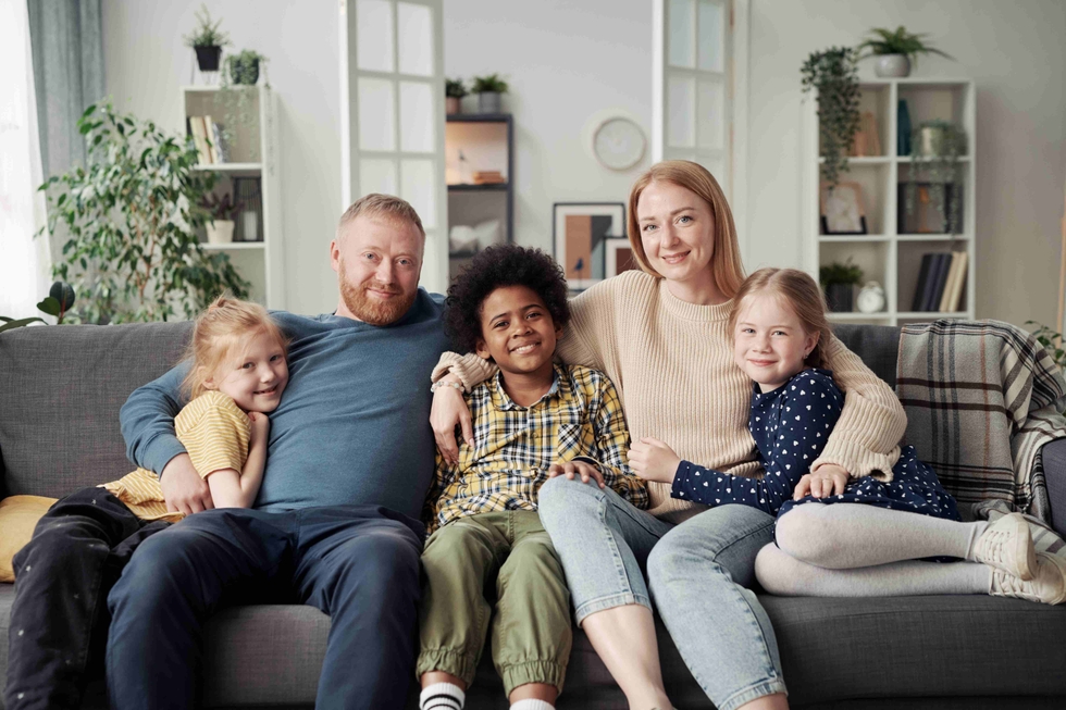 Happy_Adoptive_Family_With_Children_At_Home_original_2519933.jpg