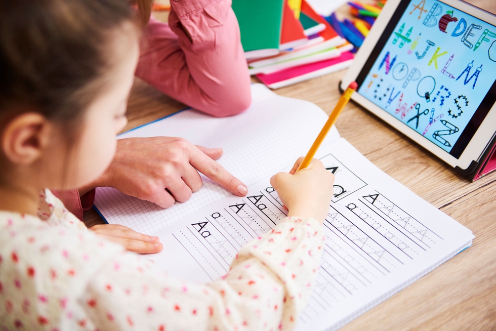 Close-Up_Of_Mother_Helping_Her_Child_With_Homework_original_3188749.jpg
