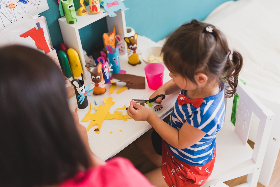granddaughter doing handycraft together with her grandmother in