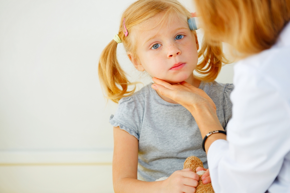 Pediatrician taking temperature with thermometer.