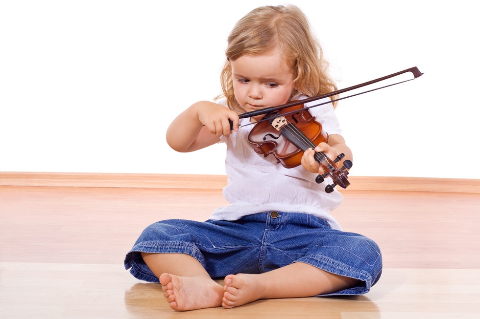 Little girl on the floor with a violin